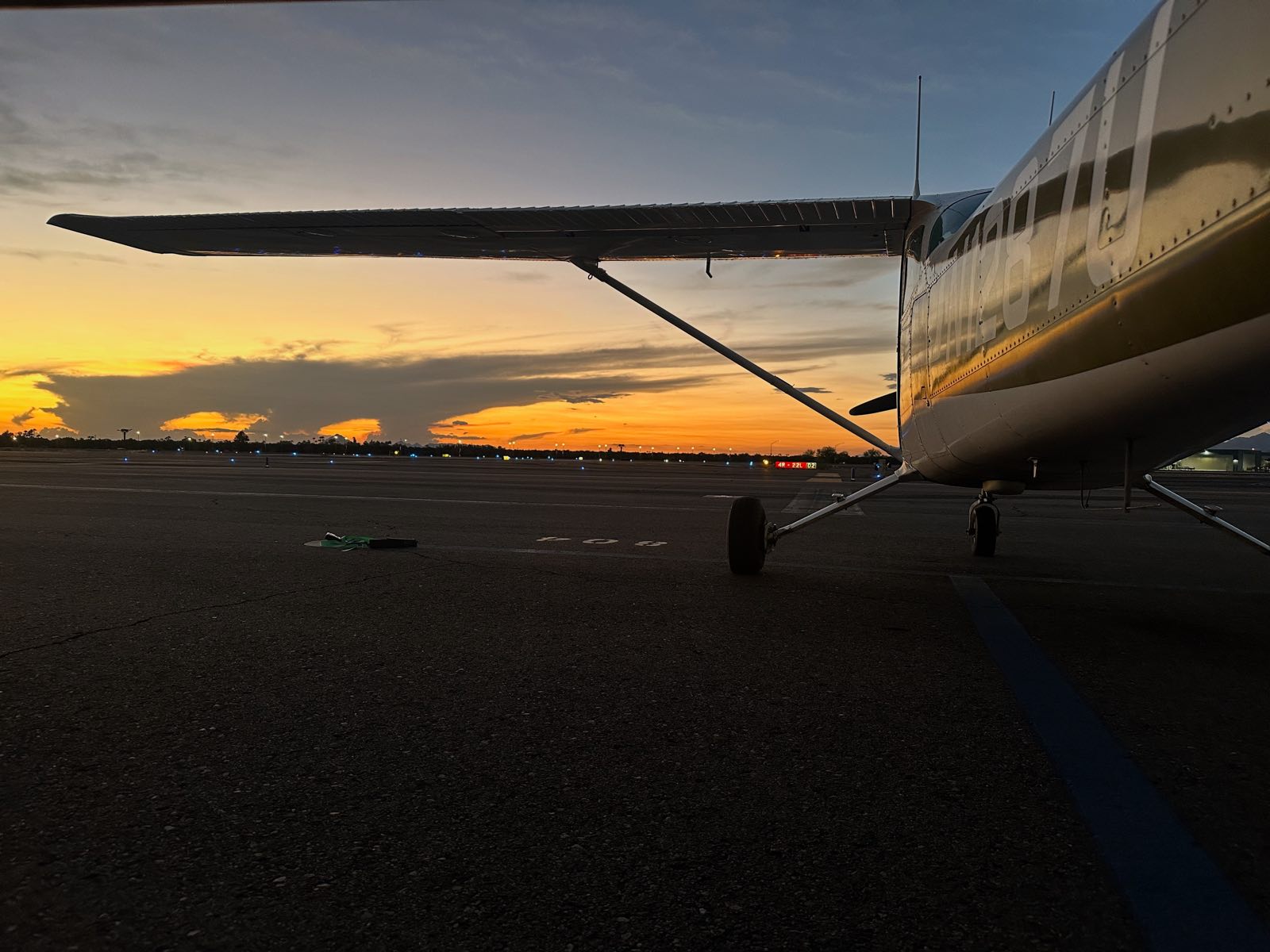 N1287U on the Falcon Field ramp at sunset, runway 4R-22L sign behind